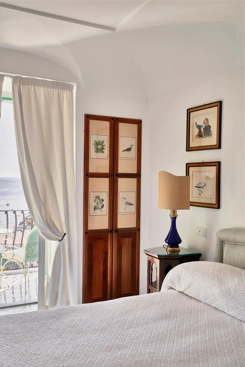 A classic room with bird prints and a sea view