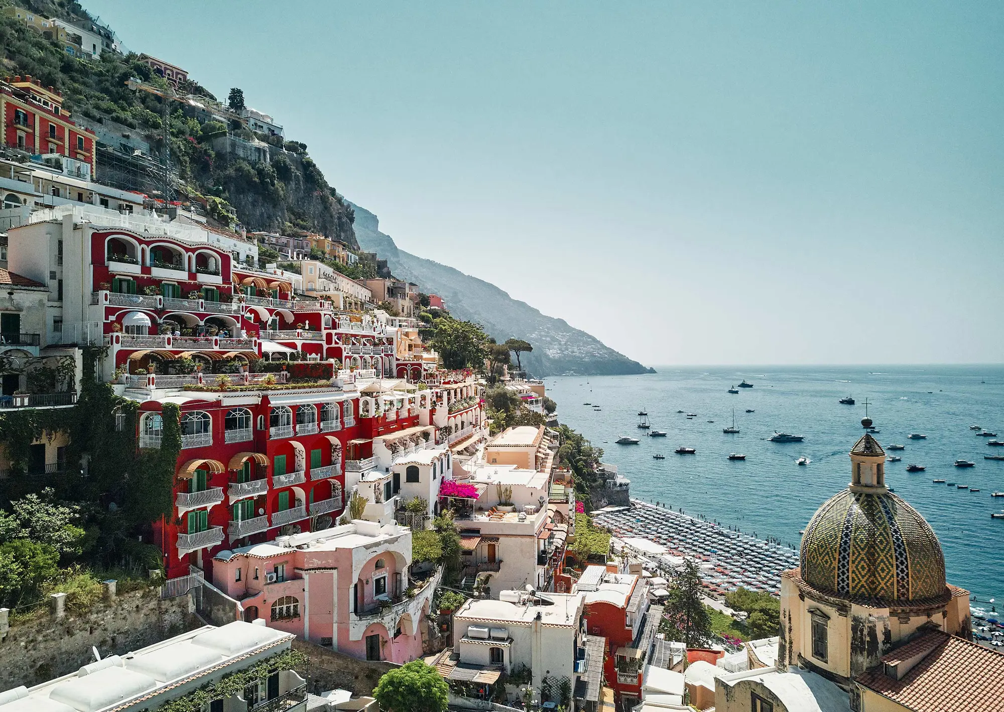 Le Sirenuse’s red terraces stepping down to the sea in Positano